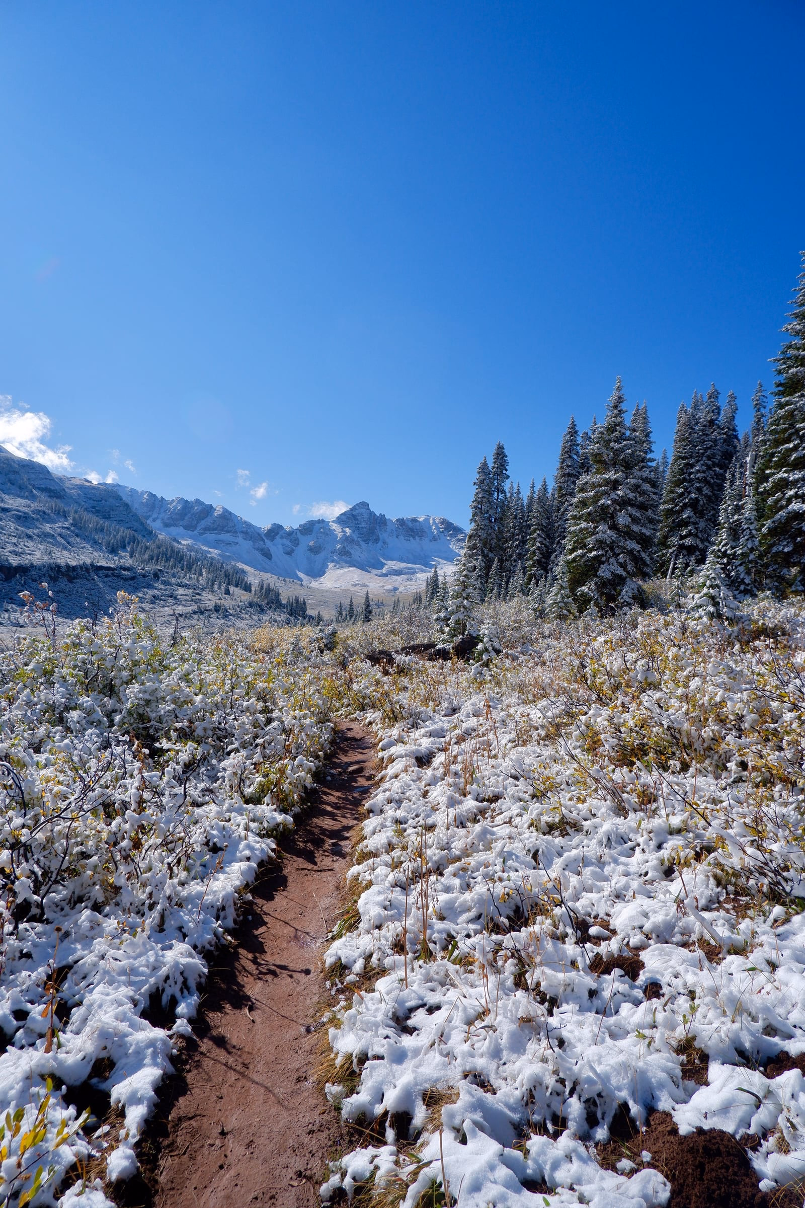 View of Maroon Bells in the valley before Frigid Air Pass on Four Pass Loop Trail.