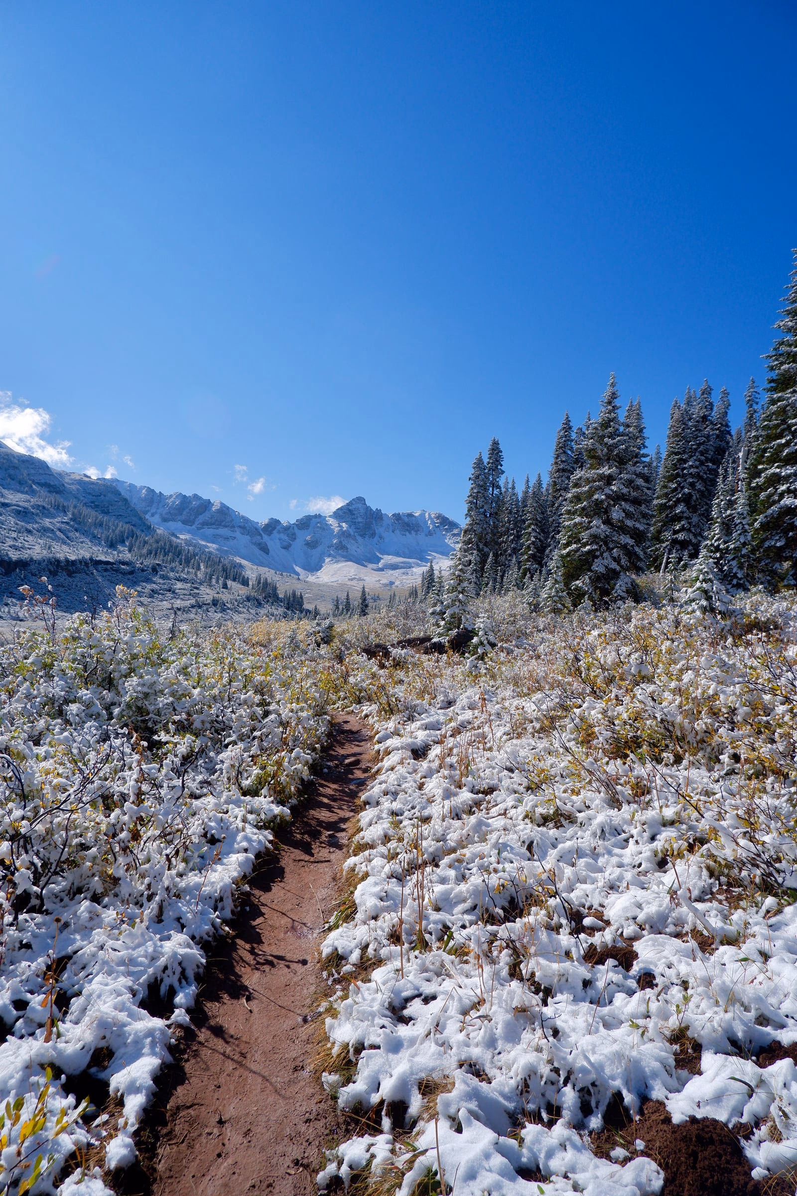 View of Maroon Bells in the valley before Frigid Air Pass on Four Pass Loop Trail.