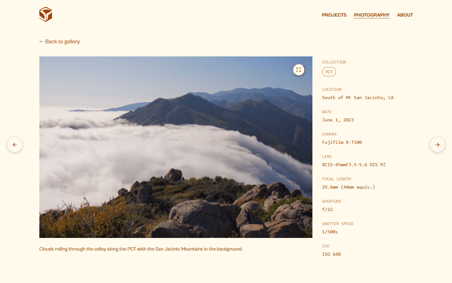 Photo detail page showing a mountain landscape alongside EXIF metadata: date, camera, lens, focal length, aperture, shutter speed, and ISO.